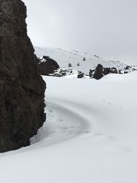 Close-up of snow on shore against sky