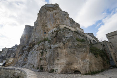 Low angle view of rock formation against sky