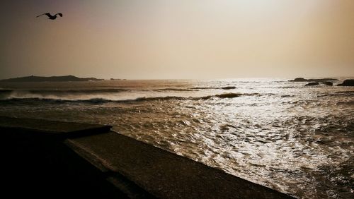 Scenic view of sea against clear sky during sunset