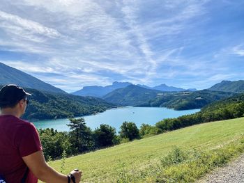 Man looking at view of mountains against sky