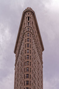 Low angle view of flatiron building against sky at dusk