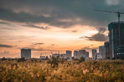 Scenic view of buildings against sky during sunset