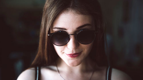 Close-up portrait of young woman wearing sunglasses