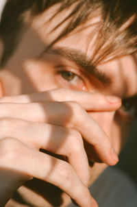 Close-up portrait of woman covering face