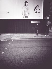 Rear view of woman standing on street