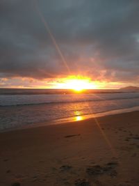 Scenic view of beach against sky during sunset