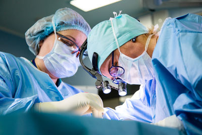 Low angle view of surgeons performing surgery