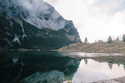 Scenic view of lake and mountains against sky