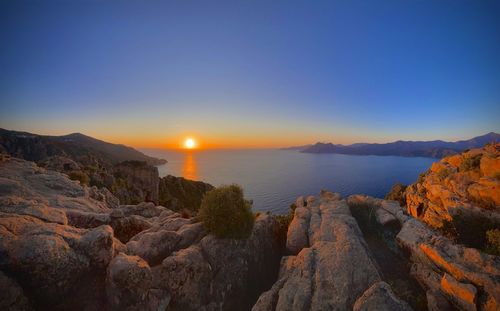 Scenic view of sea against clear sky during sunset