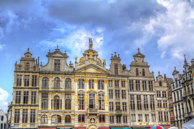 Low angle view of building against cloudy sky