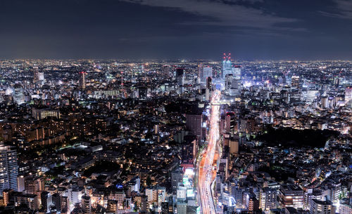 High angle view of city lit up at night