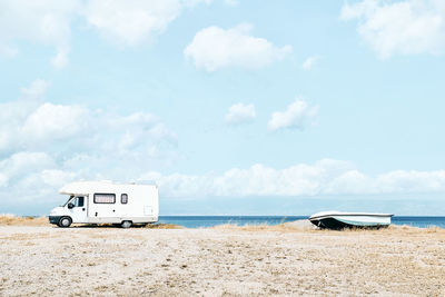 White camper van parked near the sea on the beach. tourist season on the mediterranean sea. sicily.