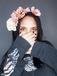 Portrait of woman with pink flower