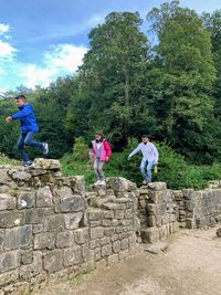 People against stone wall