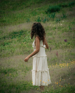 Full length of woman standing in a field