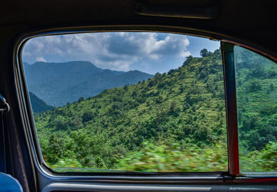 Scenic view of mountains seen through car window