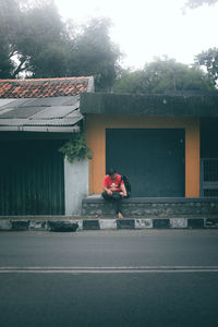 Man walking on street against building