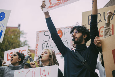 Male and female activist participating in anti-racism protest