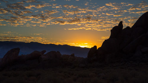 Scenic view of silhouette mountains against sky during sunset