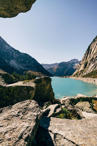 Scenic view of lake and mountains against clear blue sky