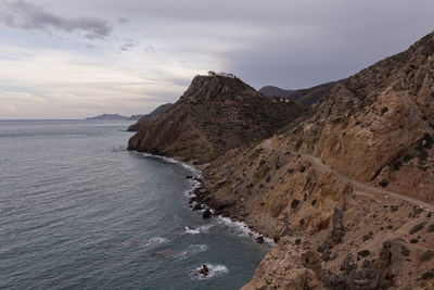 Scenic view of sea and mountains against sky