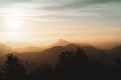 Scenic view of silhouette mountains against sky at sunset