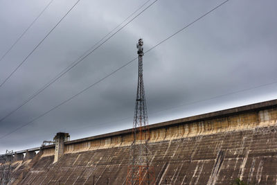 Low angle view of electricity pylon against sky