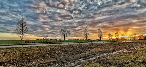 Scenic view of field against sky during sunset