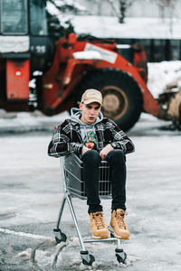 Portrait of young man sitting outdoors