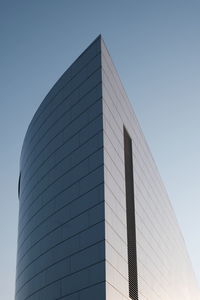 Low angle view of modern building against clear blue sky