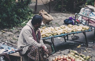 Vendor selling fruits at market stall