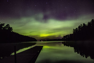 Scenic view of lake against sky at night