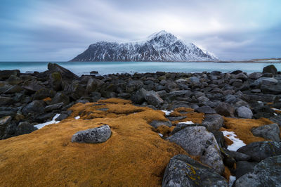 Scenic view of rocks on beach against sky norway