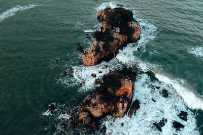 High angle view of rock formation in sea