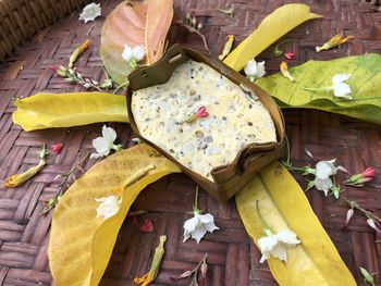 High angle view of yellow leaves on wooden floor