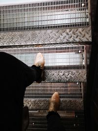 High angle view of man standing in cage