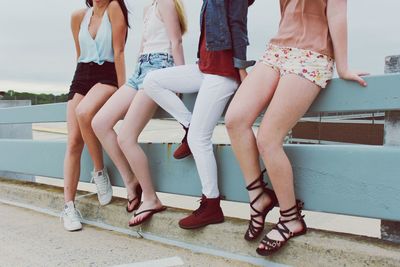 Low section of teenage girls standing outdoors