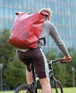 Rear view of man riding bicycle