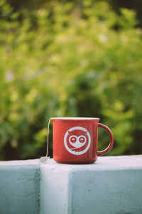 Close-up of coffee cup on retaining wall