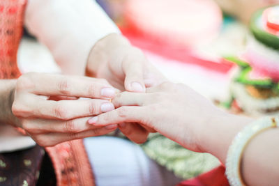 Midsection of couple holding hands