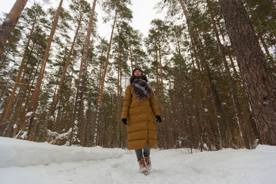 Man walking on snow covered land