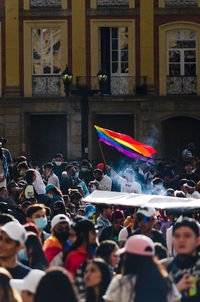 Group of people in front of building with lgbti flag