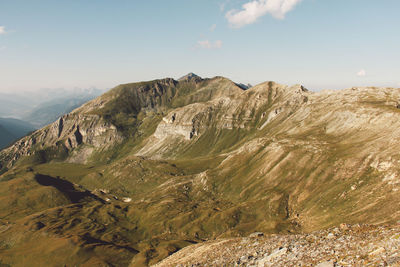 Scenic view of rocky mountains against cloudy sky