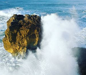 Sea waves splashing on rock