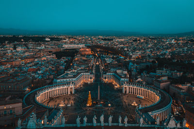 Aerial view of town square and cityscape at night