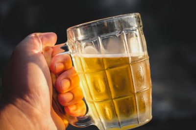 Close-up of person holding ice cream in glass