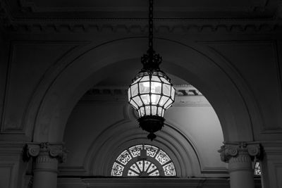 Low angle view of illuminated chandelier hanging in building