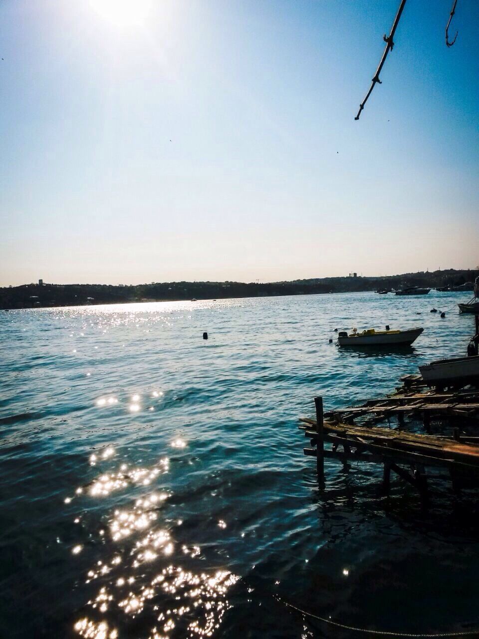 water, tranquil scene, tranquility, clear sky, scenics, reflection, beauty in nature, sea, nature, sun, nautical vessel, lake, sunlight, transportation, blue, sky, sunset, copy space, boat, idyllic