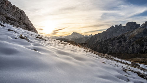 Scenic view of snowcapped mountains against sky during sunset