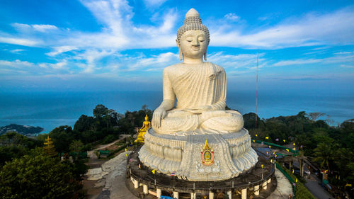 Giant buddha statue against sky